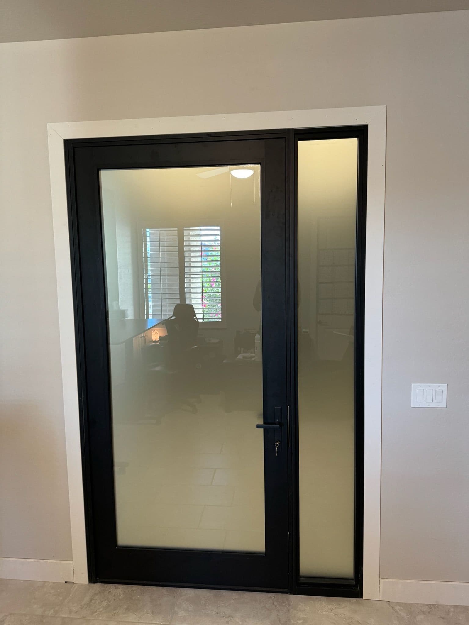 Stylish Black-Framed Glass Door Installation image